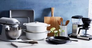 Modern kitchen essentials including mixer, cookware, and coffee maker for dowry setup.