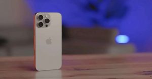 Close-up shots of a white iPhone 16 Pro with triple camera setup on a wooden table.