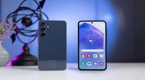 Samsung smartphone with triple rear cameras and front display showing weather and apps, captured on a minimalist modern desk.