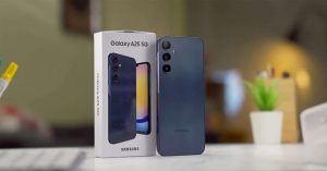 Samsung Galaxy A25 5G smartphone displayed next to its retail box, set on a desk with indoor lighting.