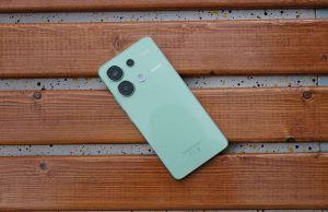 Green Redmi smartphone placed on a wooden surface, captured from different angles.