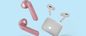 Pink and white wireless earbuds with charging case on blue background.