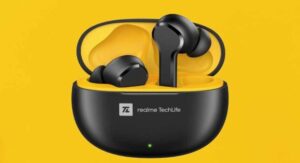 Black Realme TechLife earbuds in yellow charging case on bright yellow background.