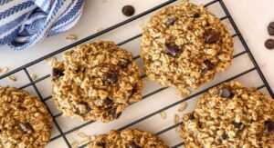 Oatmeal chocolate chip cookies cooling on a wire rack.