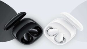  Black and white wireless earbuds in open charging cases on a gray background.
