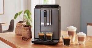 Bosch fully automatic coffee machine with cups and coffee beans on kitchen counter.