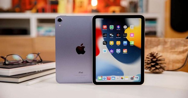 iPad Mini on desk with screen and back view visible.