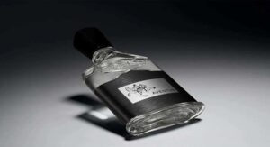 Creed Aventus men's perfume bottle lying on a dark background