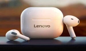 White Lenovo wireless earbuds and charging case on a dark surface.
