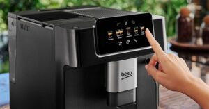 Hand selecting coffee type on touchscreen of Beko espresso machine.