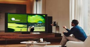 Man watching golf on smart TV in modern living room.