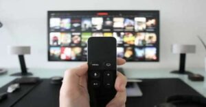 ChatGPT said:
Hand holding TV remote with smart TV interface in background.