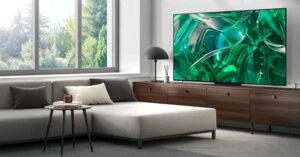 Modern living room with a large flat-screen TV and green abstract display.