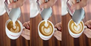 Step-by-step latte art being poured into a cup of coffee with milk froth.