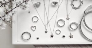 silver necklaces, rings, and bracelets displayed neatly on a white tray