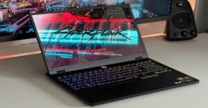 Gaming laptop displaying Cyberpunk 2077 with a colorful RGB keyboard.