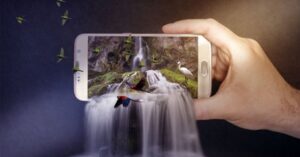 Creative image of a smartphone displaying a waterfall with water and birds flowing out.