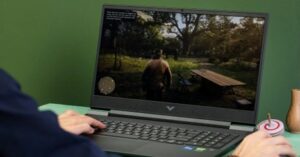 Close-up of a person playing a video game on a Victus gaming laptop.