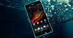 Waterproof smartphone submerged underwater with bubbles surrounding the screen.