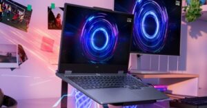 Lenovo LOQ laptop on a stand with an external monitor in a gaming setup.