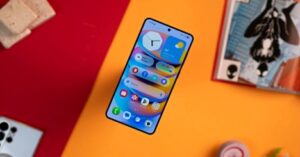 Samsung smartphone showing One UI home screen with colorful widgets and app icons