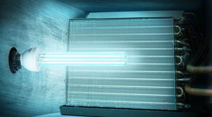 UV-C light bulb installed next to metal cooling coils in an HVAC system.