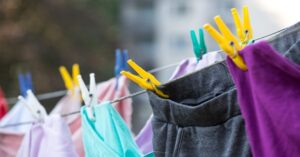 Clothes drying outdoors on a clothesline with colorful clothespins