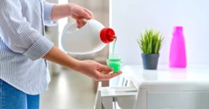 Pouring liquid laundry detergent into the washing machine detergent compartment