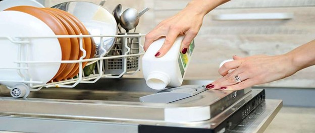 Pouring liquid dishwasher detergent into the dishwasher detergent compartment