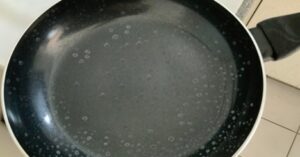 White water spots on a nonstick pan after dishwasher washing