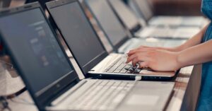 multiple laptops in use highlighting performance comparison and need for faster system efficiency