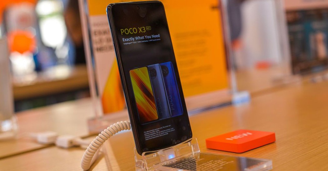 Poco X3 smartphone displayed in a Xiaomi store