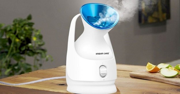 Facial steamer producing warm mist on a wooden table