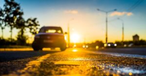 hot asphalt road under sunlight causing tire wear and reduced tire lifespan in summer driving
