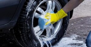 cleaning car tire and rim with sponge helps maintain tire condition and extend lifespan
