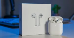 AirPods with charging case placed beside the original product box