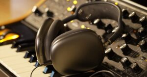 AirPods Max headphones on music production equipment for studio audio and editing
