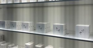AirPods boxes displayed on store shelves for model selection and buying guide