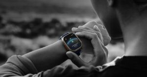 Person checking Apple Watch Ultra health metrics outdoors