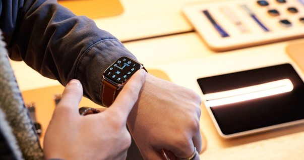 Person using Apple Watch in a store environment