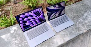 Two MacBook Air laptops outdoors showing different sizes and colorful displays