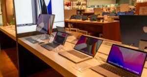 MacBook models displayed in a retail store for comparison and purchase decisions
