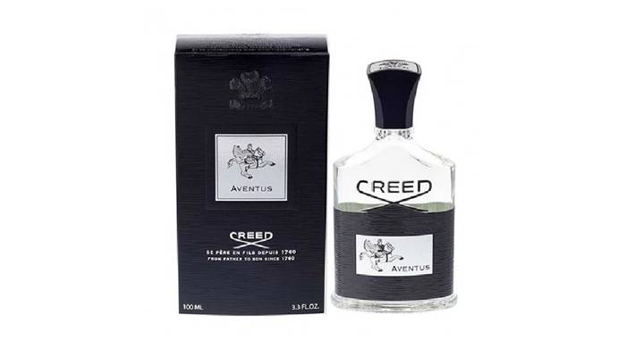 Creed Aventus perfume bottle with matching black packaging on a white background. 