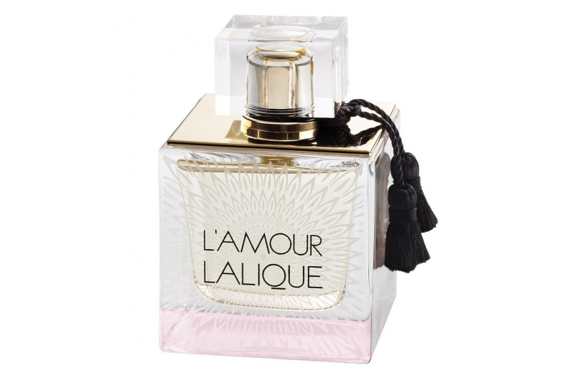 Lalique L’Amour perfume bottle with clear cap and black tassel on a white background
