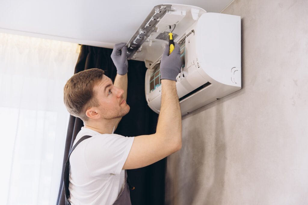 Technician repairing the indoor unit of a wall-mounted split air conditioner

