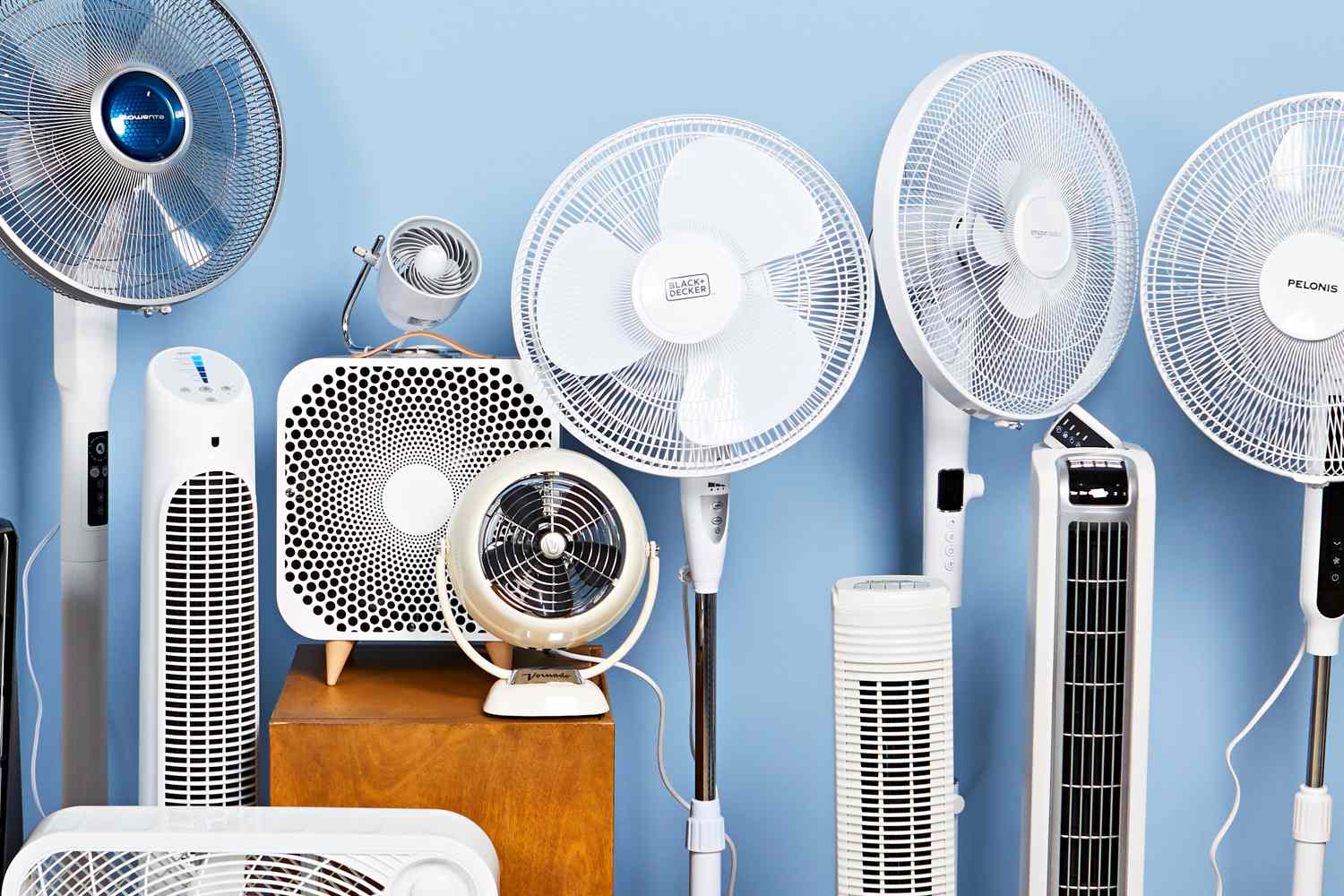 Multiple types of fans and portable air coolers displayed against a blue background