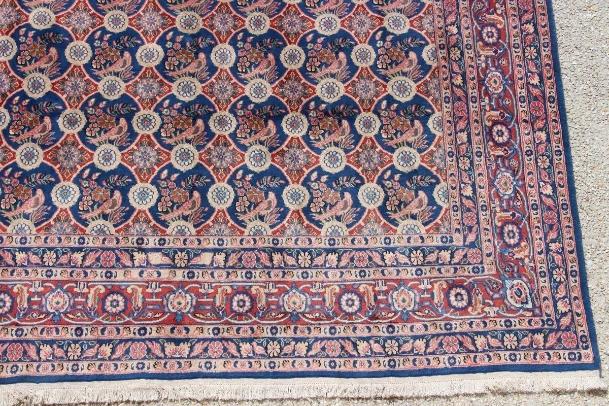 Traditional Persian rug with floral patterns and decorative border design.