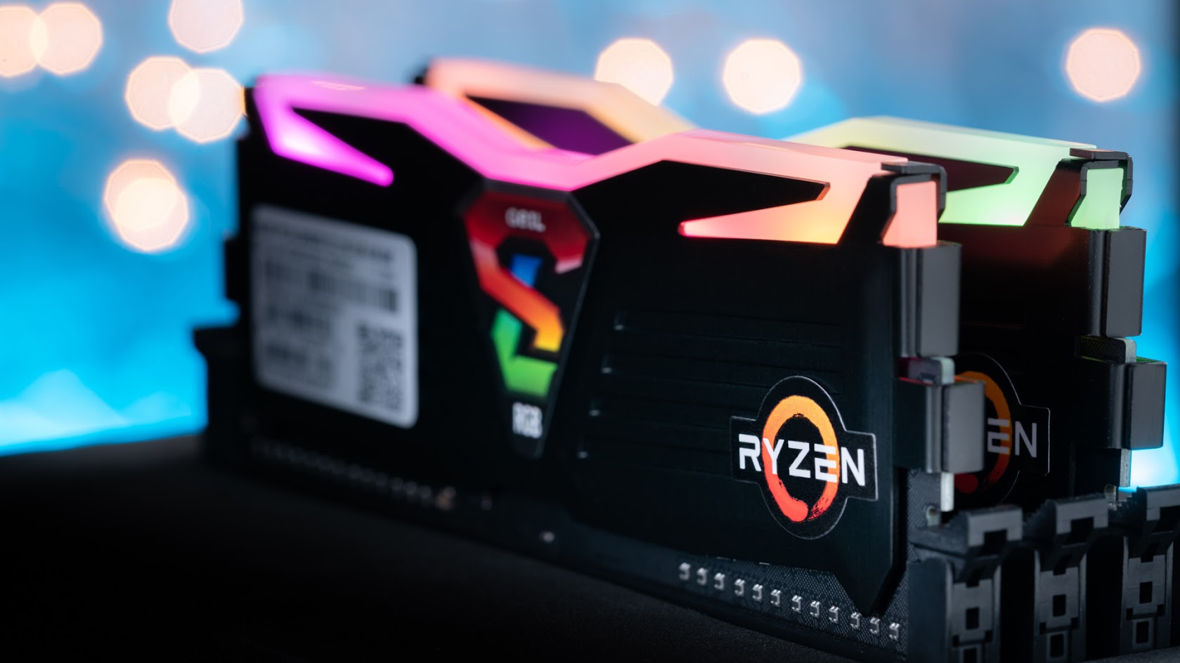RGB gaming RAM modules with colorful lighting installed on a Ryzen-based computer setup.