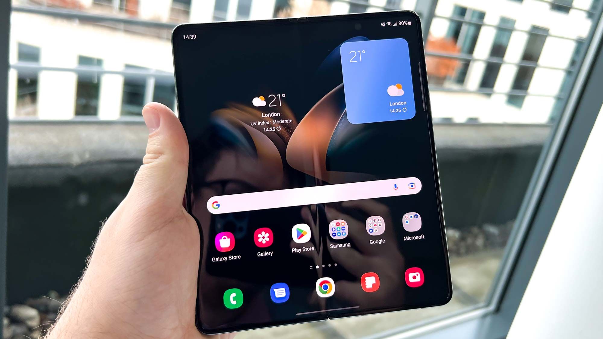 Person holding an open Samsung Galaxy Z Fold smartphone with large tablet-like display.