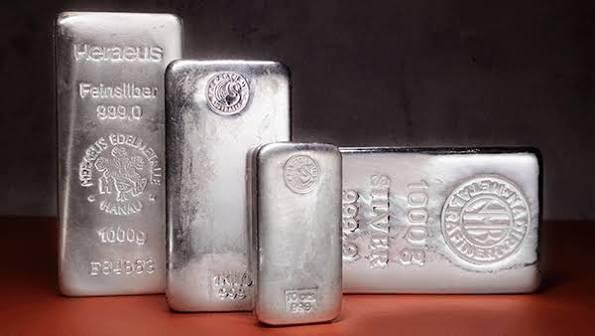 Silver bars of various sizes and weights displayed upright against a dark background